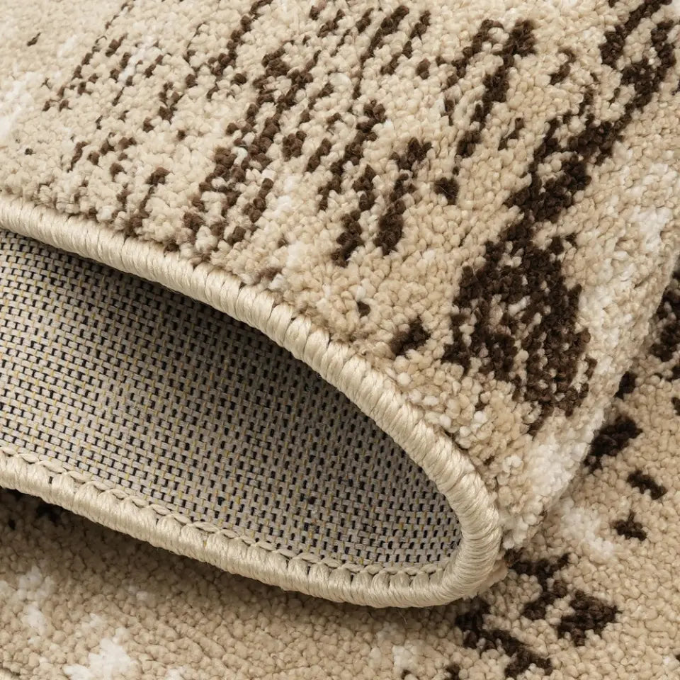 Close-up of a beige and brown patterned rug with a textured surface.
