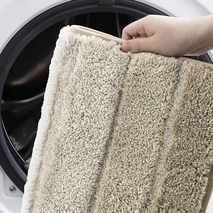 Rug being held in front of a washing machine