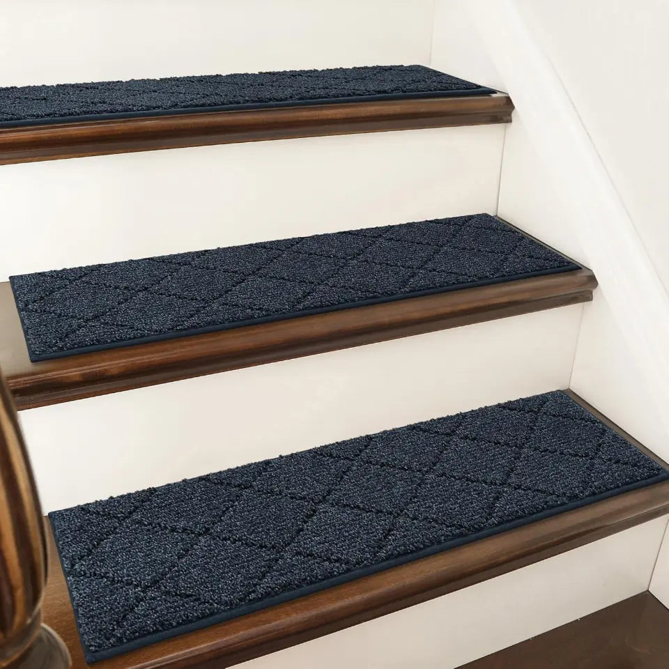Navy blue diamond-patterned stair treads on wooden stairs.