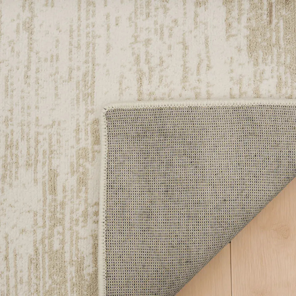 Beige textured rug on a wooden floor