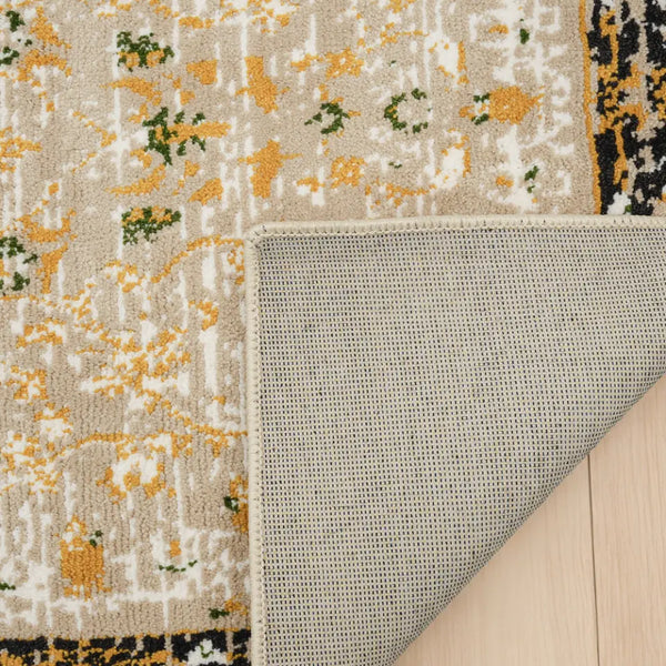 Patterned rug with a textured border on a wooden floor