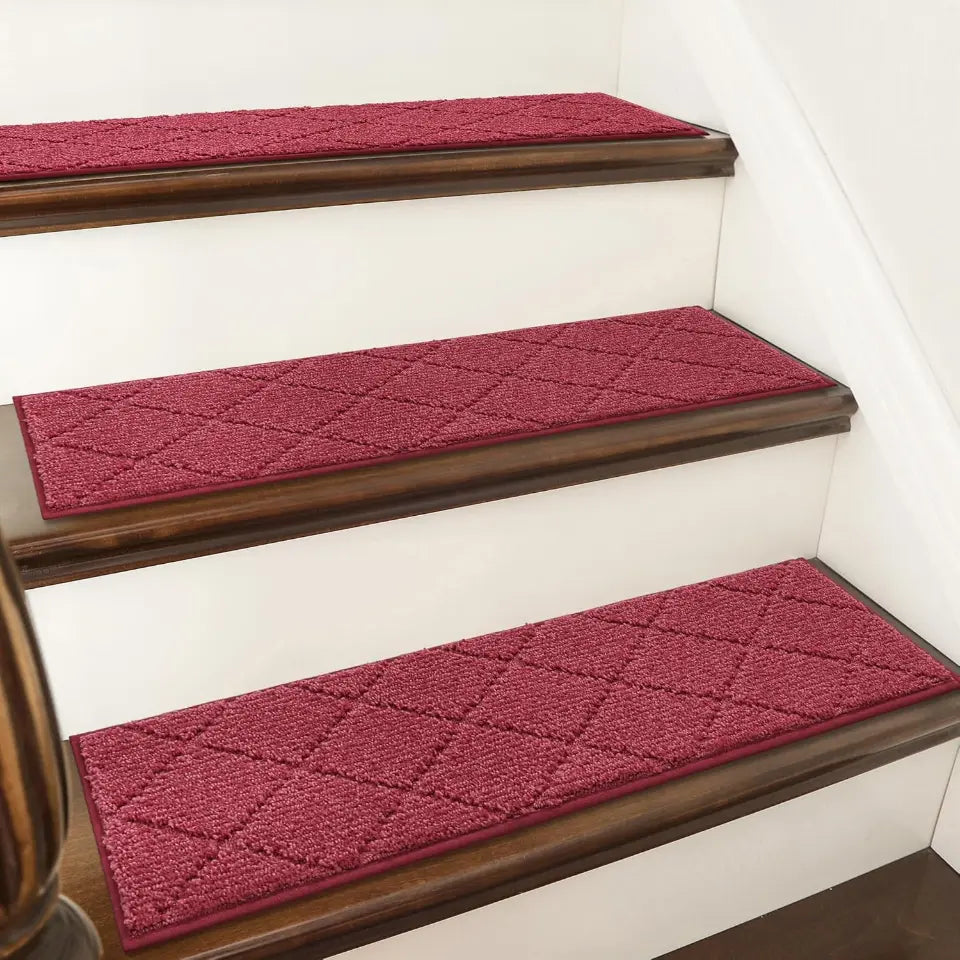 Red diamond-patterned stair treads on a staircase with wooden risers.